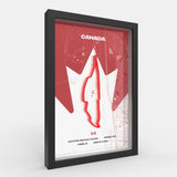 A framed Canada racing map print with a black frame, featuring a red maple leaf outline and track graphic on a white background with faint map details.