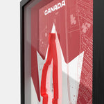 Framed poster with a red and white design featuring the word 'Canada'.