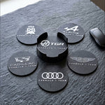 Close-up of Formula 1 team logo coasters set with 3D printed holder on textured surface