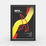 A framed poster featuring the Spa-Francorchamps race track layout in Belgium, with a black background, bold yellow and red graphic elements, and white text including 'SPA FRANCORCHAMPS'. The poster is shown inside a black frame against a light gray studio background.
Spa Francorchamps F1 track framed wall art front view