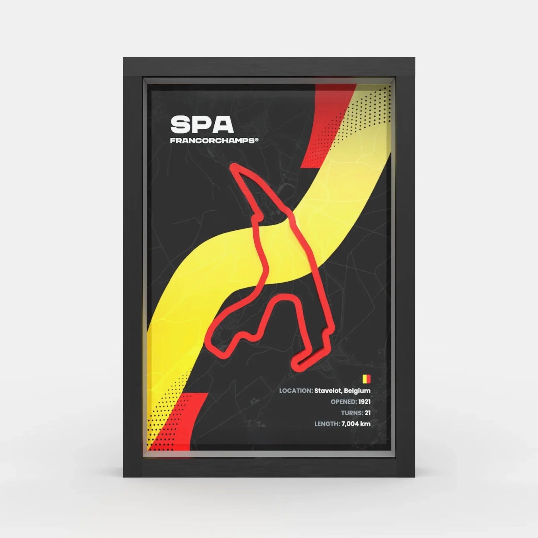 A framed poster featuring the Spa-Francorchamps race track layout in Belgium, with a black background, bold yellow and red graphic elements, and white text including 'SPA FRANCORCHAMPS'. The poster is shown inside a black frame against a light gray studio background.
Spa Francorchamps F1 track framed wall art front view