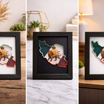 “Iran map 3D wall art in black frame with lion and sun design on a desk”
